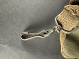 a small bag with a hook attached to it ' s side