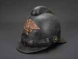 an old fireman ' s helmet with an eagle emblem on it