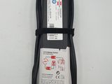 a close up of a black charger on a white surface