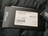 the label on the back of a black down jacket that says feed down west