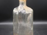 a clear glass bottle with a clear lid on a table