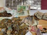 a pile of money sitting on a table next to a bag of coins