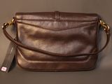 brown leather cross body bag with gold hardware and strap