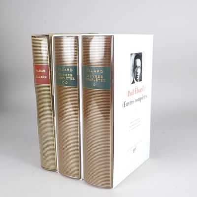 three books are stacked on top of each other on a white surface
