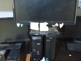 a computer desk with a monitor, keyboard, and mouse