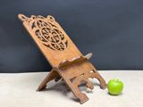 a small wooden stand with a green apple on it