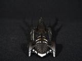 a close up of a toy batmobile on a black surface