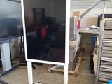 a television on a stand in a garage