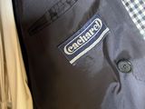 the back of a black and white jacket with a blue logo on it