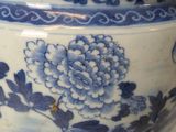 a blue and white bowl with a lid on a table