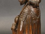 bronze statue of a woman with a dog and a cat on a stand