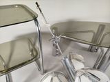 a glass table and two chairs next to each other