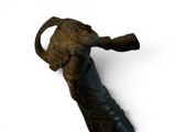 a statue of an elephant that is holding a piece of wood in its mouth