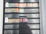 a picture of a man taking a picture of stamps on a wall