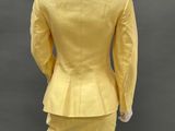 a mannequin wearing a yellow suit and skirt on a mannequin mannequin mannequin mannequin mannequin mannequin manne