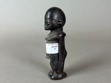 figurine of a man with a sign on his chest