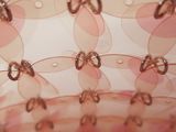 a close up view of a pink bag with bows on it