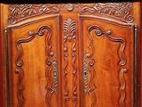 a wooden cabinet with two doors and a shelf