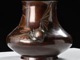 a brown vase sitting on top of a white table