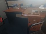 a desk with a chair and a computer on it