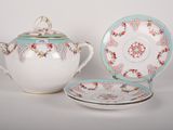 a teapot and saucer sitting next to each other on a table
