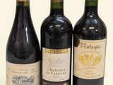 three bottles of wine are lined up on a white surface