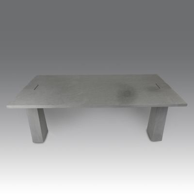 the table is made of concrete and has a metal base