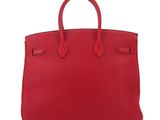a red leather handbag on a white background