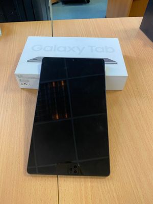 une photo d'un téléphone portable noir posé sur une table en bois
