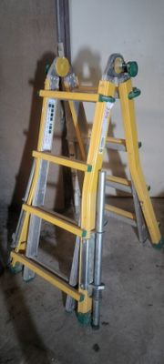 a yellow ladder that is leaning against a wall