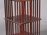 an antique wooden shelf with three shelves on each side and a shelf on the other side