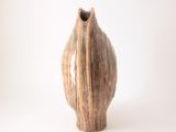 a small vase that is sitting on a white surface