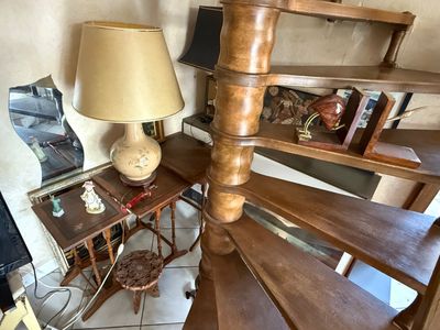 a lamp that is sitting on a table next to a spiral staircase
