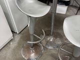 two stools and a table in a small room