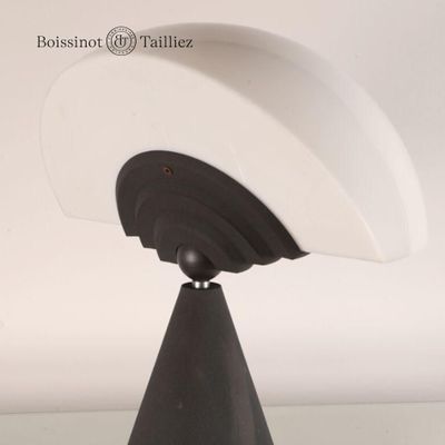 a close up of a lamp on a stand on a table