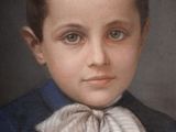 portrait of a young boy wearing a blue shirt and a white bow tie