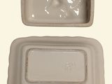 a white container with a lid and a plastic container with a lid