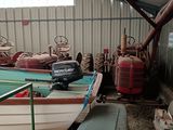 a small boat sitting in a shed next to a small boat