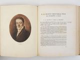 an open book with a picture of a man in a suit and tie