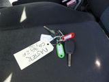 a car seat with keys and a tag on it