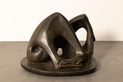 bronze sculpture of a woman ' s head on a plate on a table