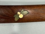 a close up of a wooden bat with a butterfly on it