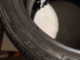 a tire that is sitting on the floor next to a wheel