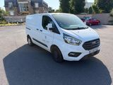 the white van is parked in the parking lot