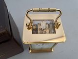 a gold clock sitting next to a black clock