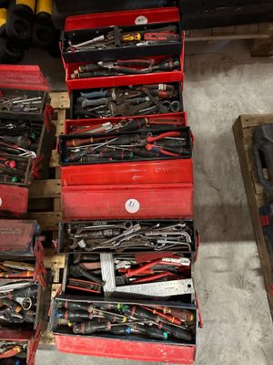 a lot of tools in a red box on the floor