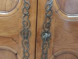 two wooden doors that have metal handles on them