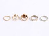five different types of rings sitting on top of a white surface