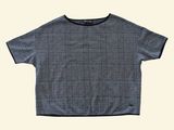 the shirt is blue and white checkered with a black collar