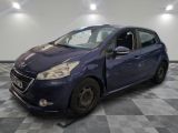 the small blue car is parked on a checkered floor